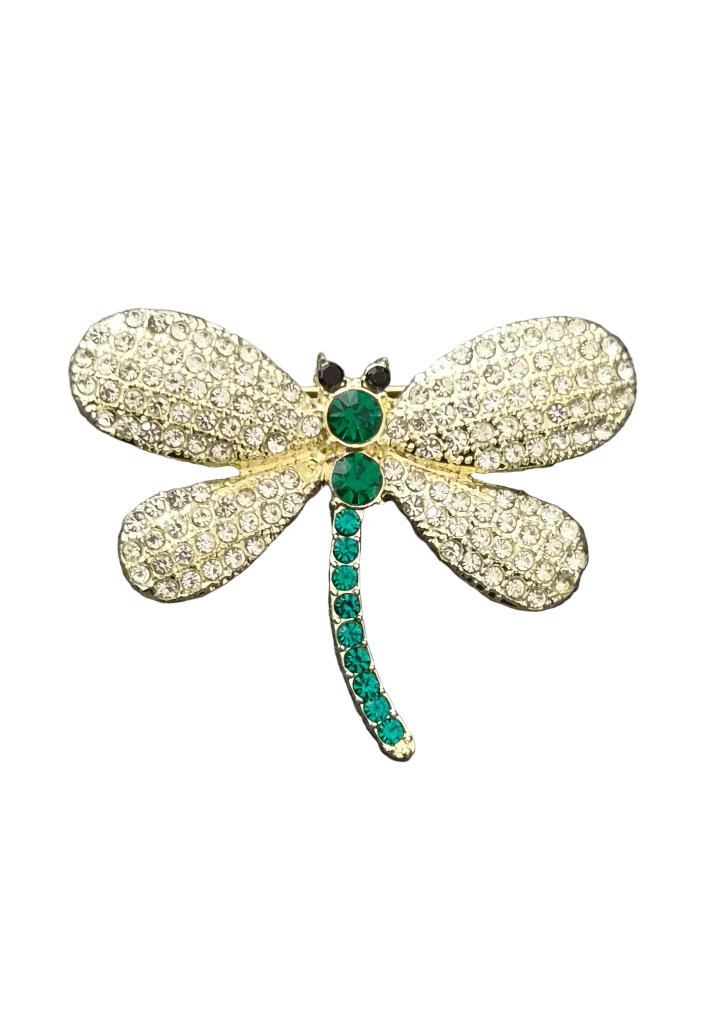 A dragonfly-shaped brooch with textured gold wings and green gemstone accents on the body and tail.