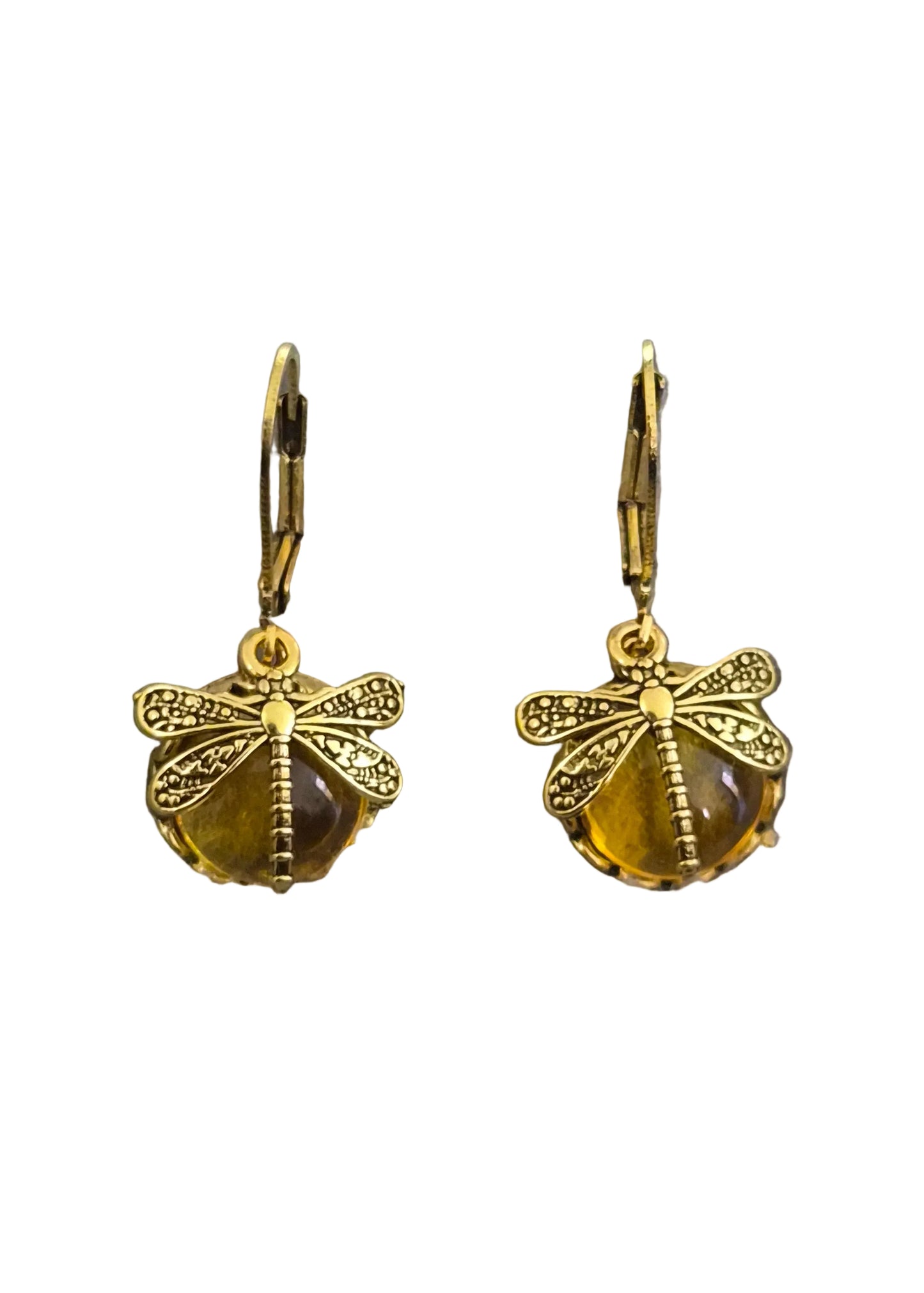 A pair of gold dragonfly drop earrings with textured wings and a faceted amber-yellow bead below.