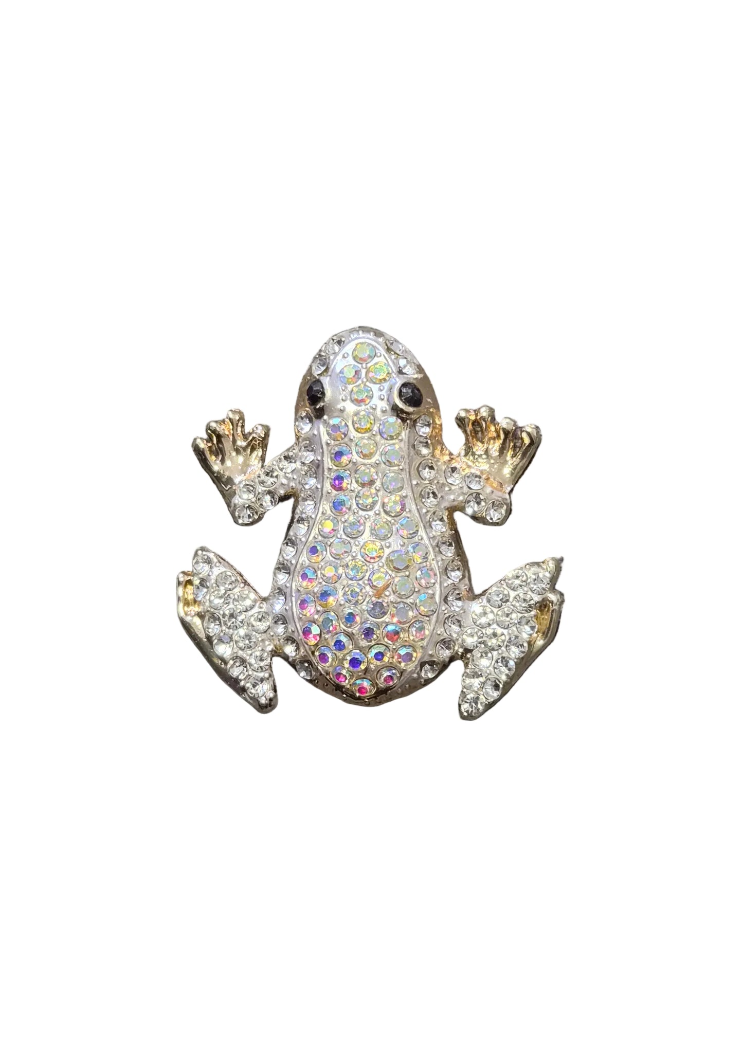 A small frog-shaped brooch or pin covered in iridescent rhinestones, shown on a textured gray fabric background.
