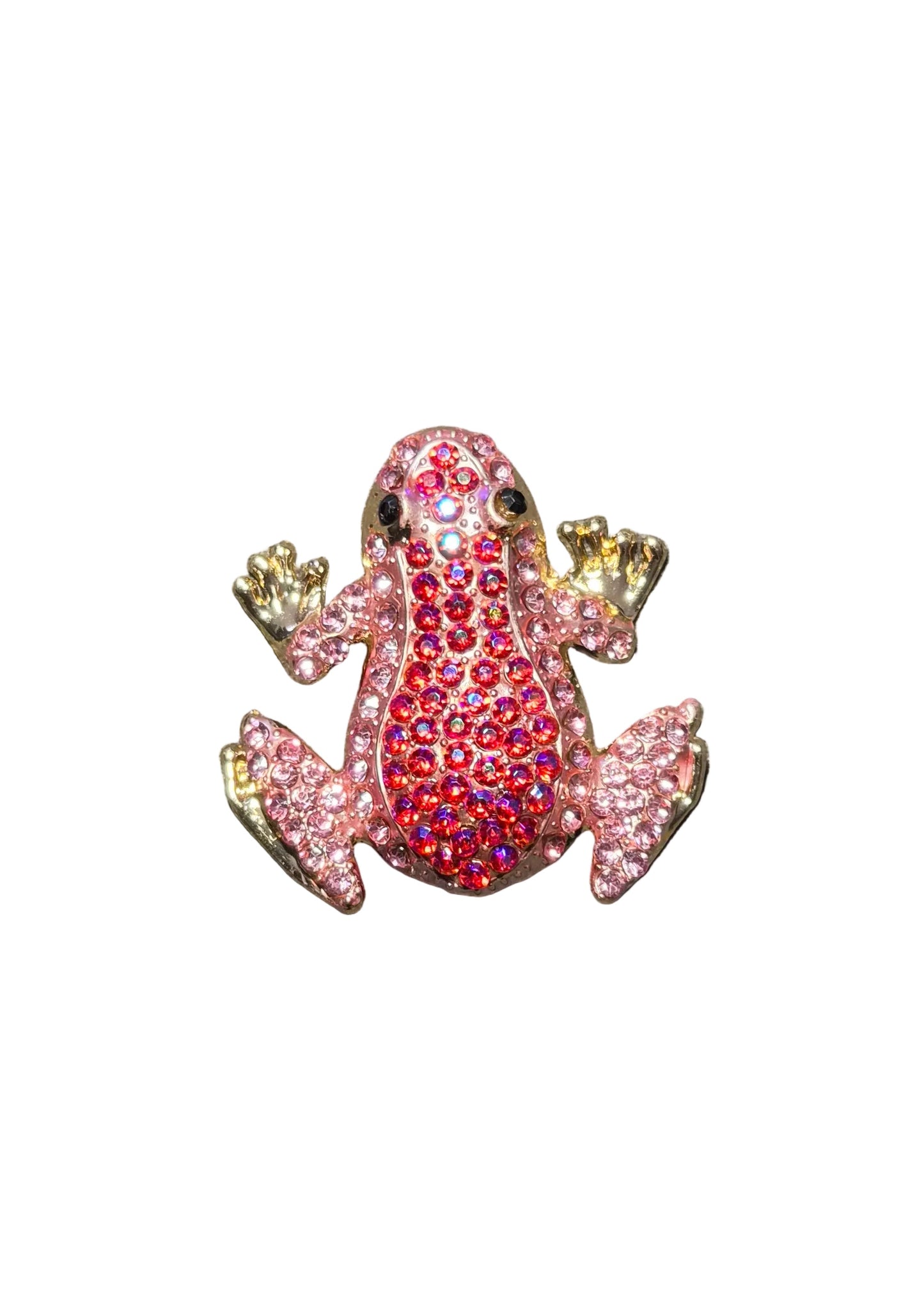 A small frog-shaped brooch or charm covered in rhinestones, with a pink body, red center, and gold-toned limbs