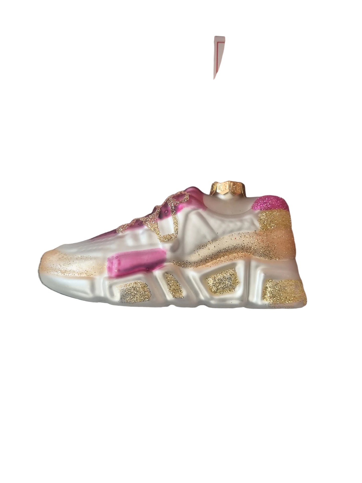 Decorative shoe ornament with gold and pink details 