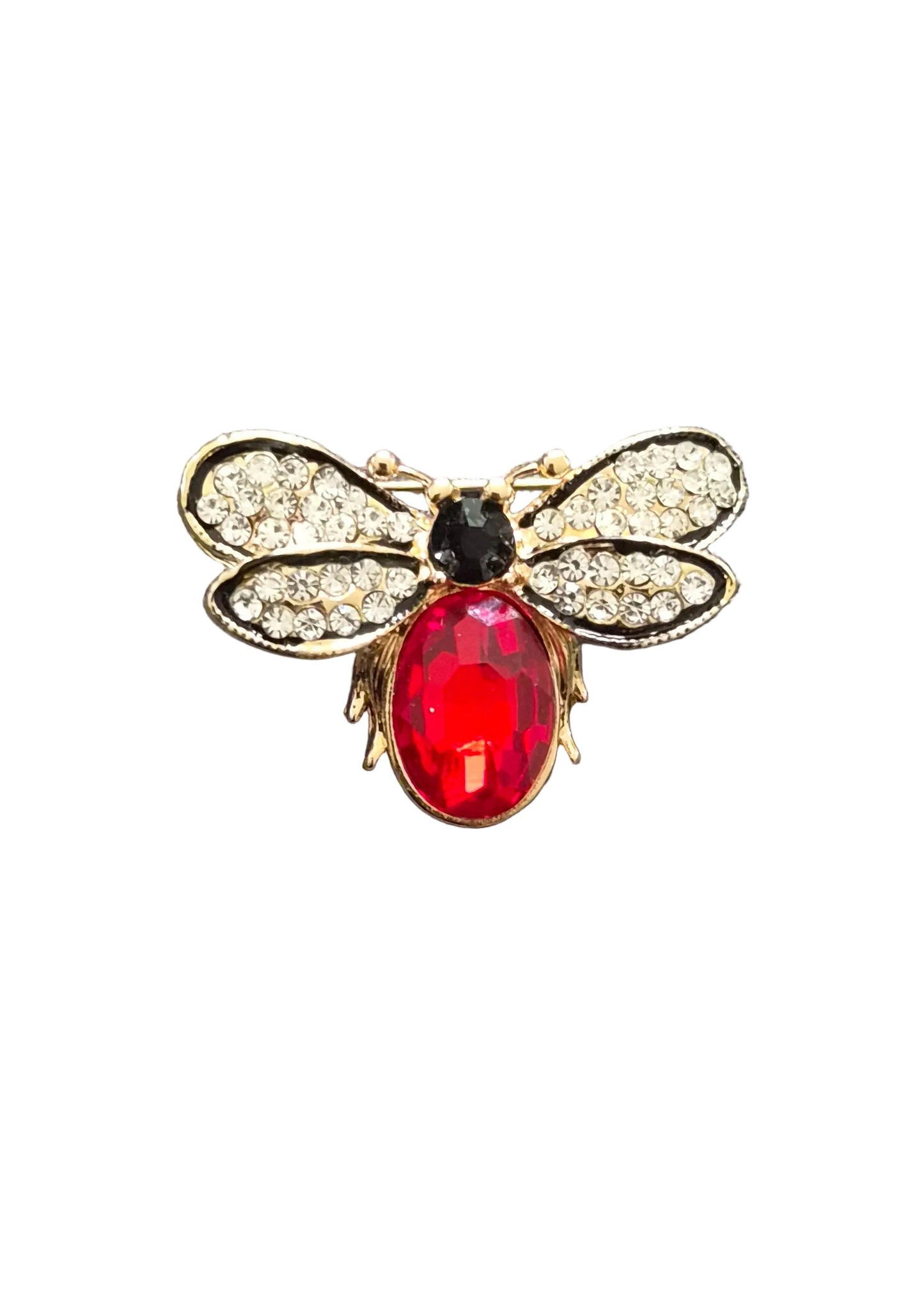 A gold-tone bee-shaped brooch with a large red oval rhinestone body, a small black oval head, and clear crystal wings.