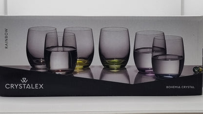 Box of Crystalex glasses with six colored glasses on a white surface.