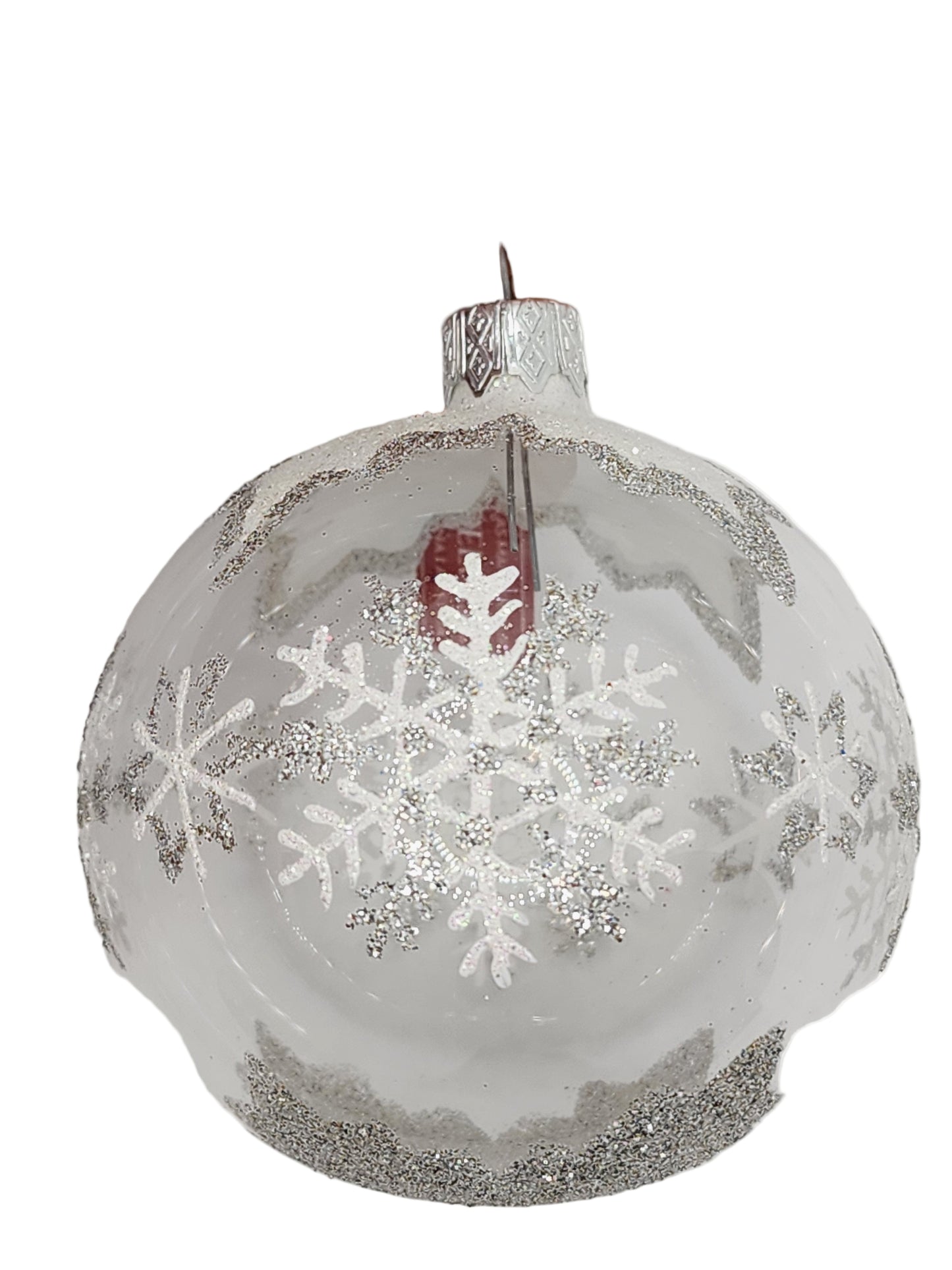 Clear glass ornament with snowflake design against a light gray background