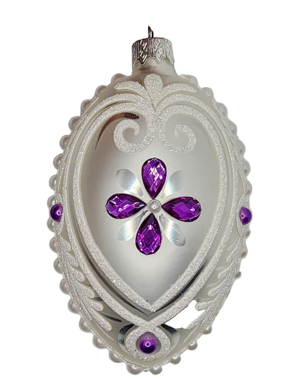 Decorative object with purple gemstones on a white background