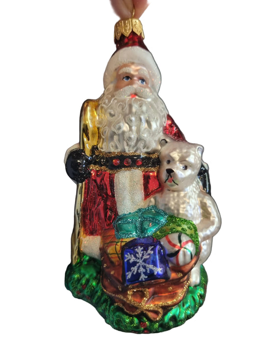 Decorative Christmas ornament of Santa Claus with a dog and presents