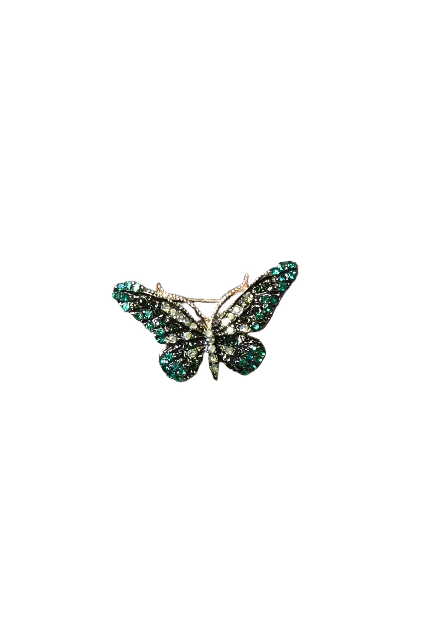 A butterfly-shaped brooch with green crytals and a silver-toned center