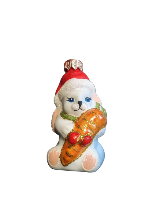 Small figurine of a rabbit holding a carrot glass Christmas ornament 