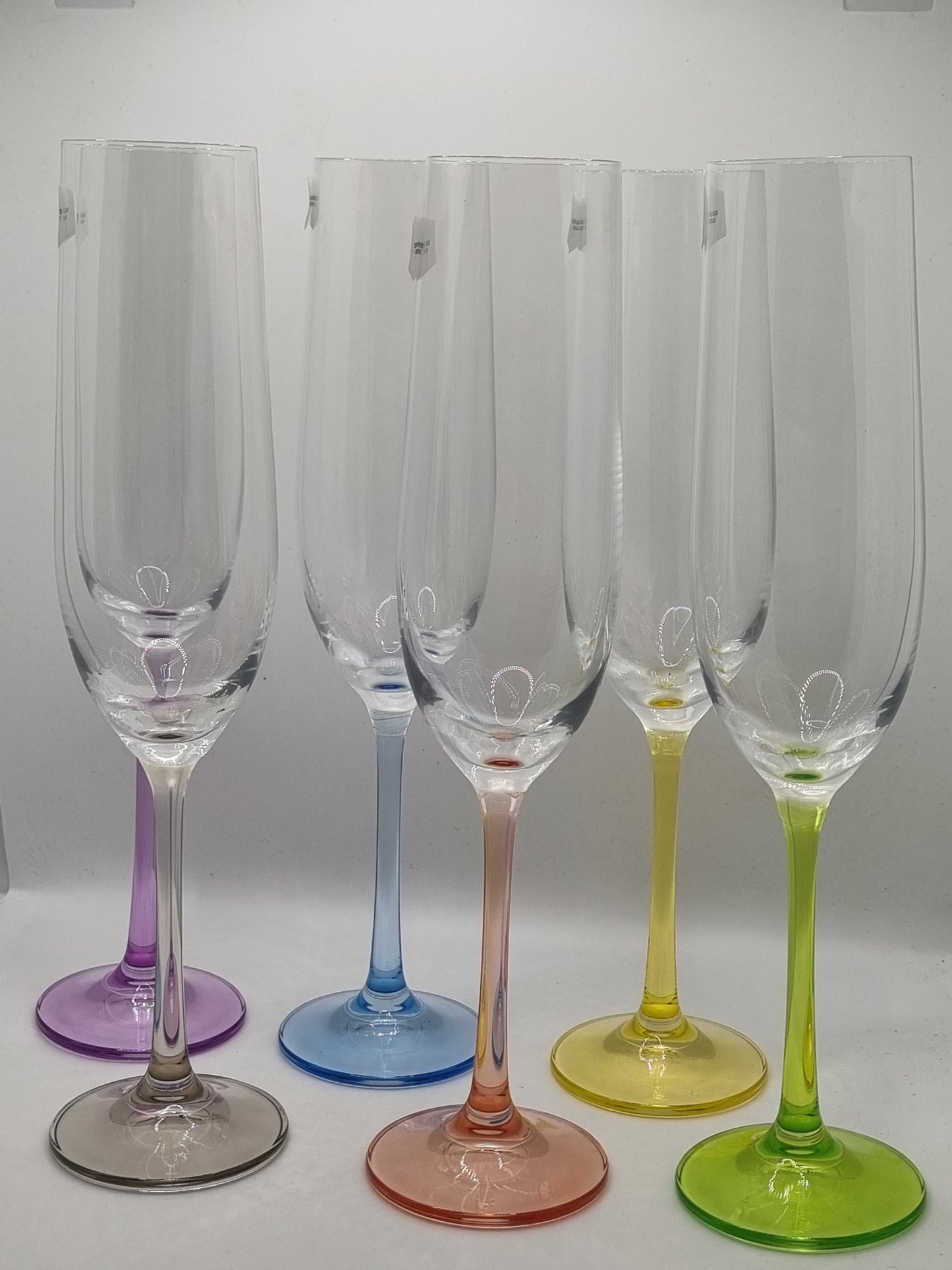 Set of coluorful champagne glasses on a white background
