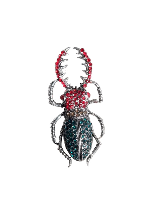 Decorative beetle-shaped brooch with red and green accents 