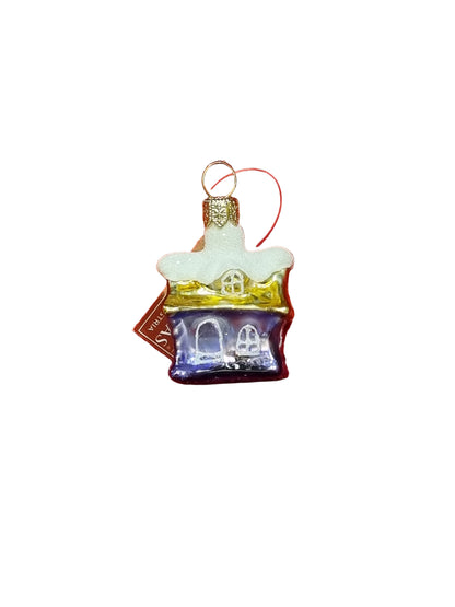 Glass ornament shaped like a house with a white roof on a white background