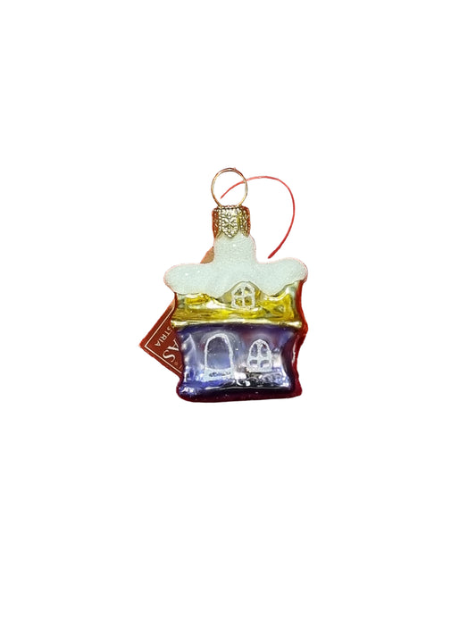 Glass ornament shaped like a house with a white roof on a white background